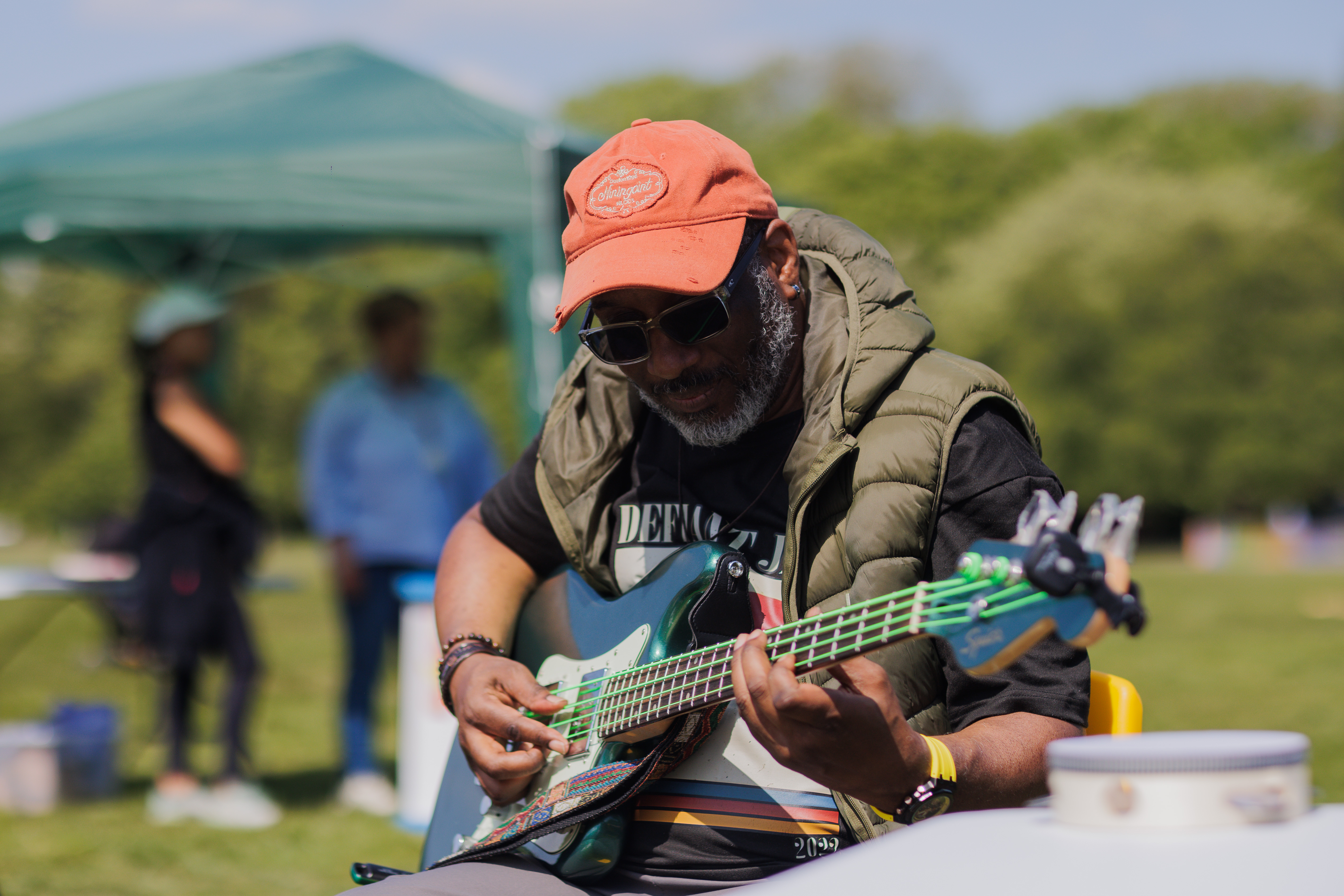 a man plays guitar at a summer event
