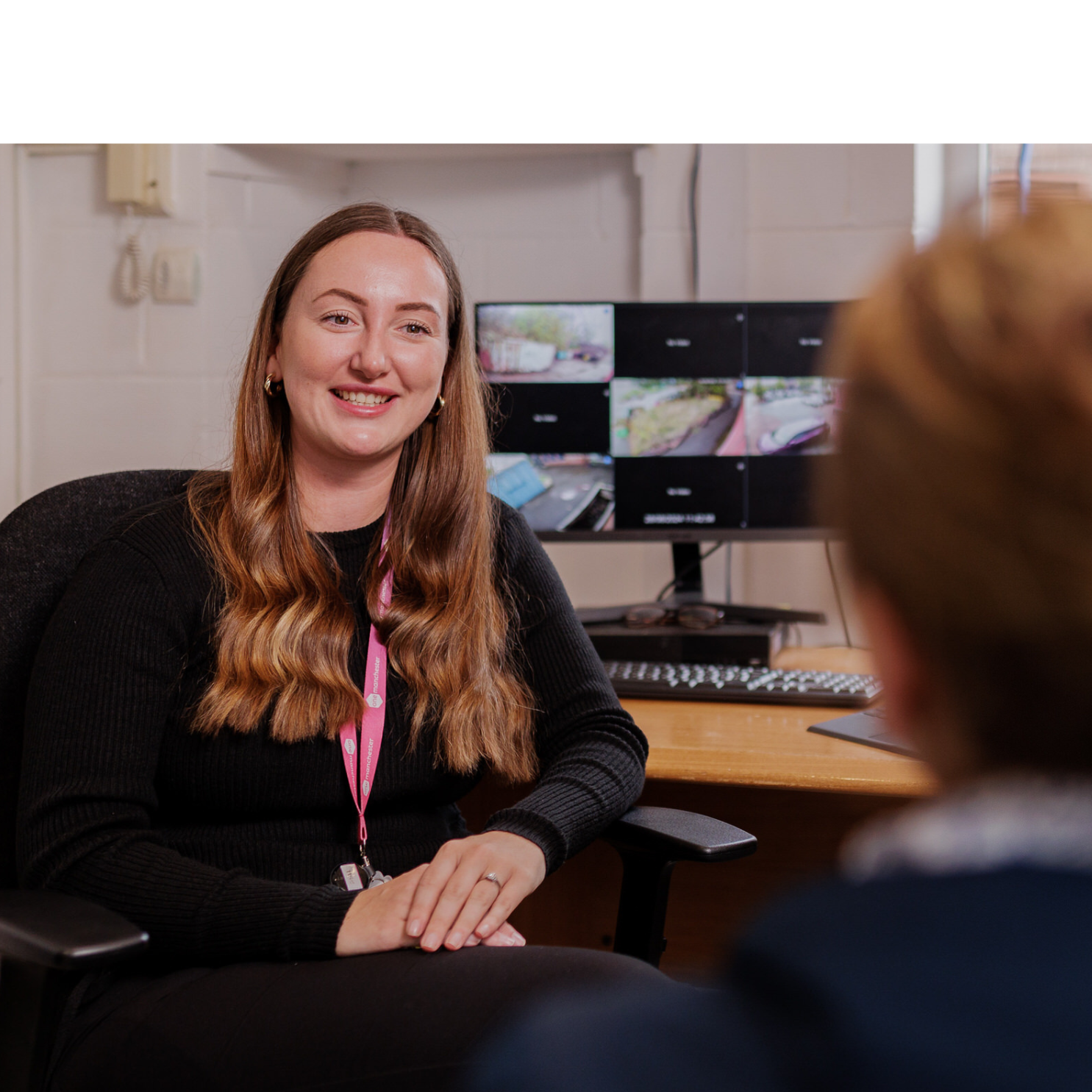 One Manchester collegues talking to customer in office setting