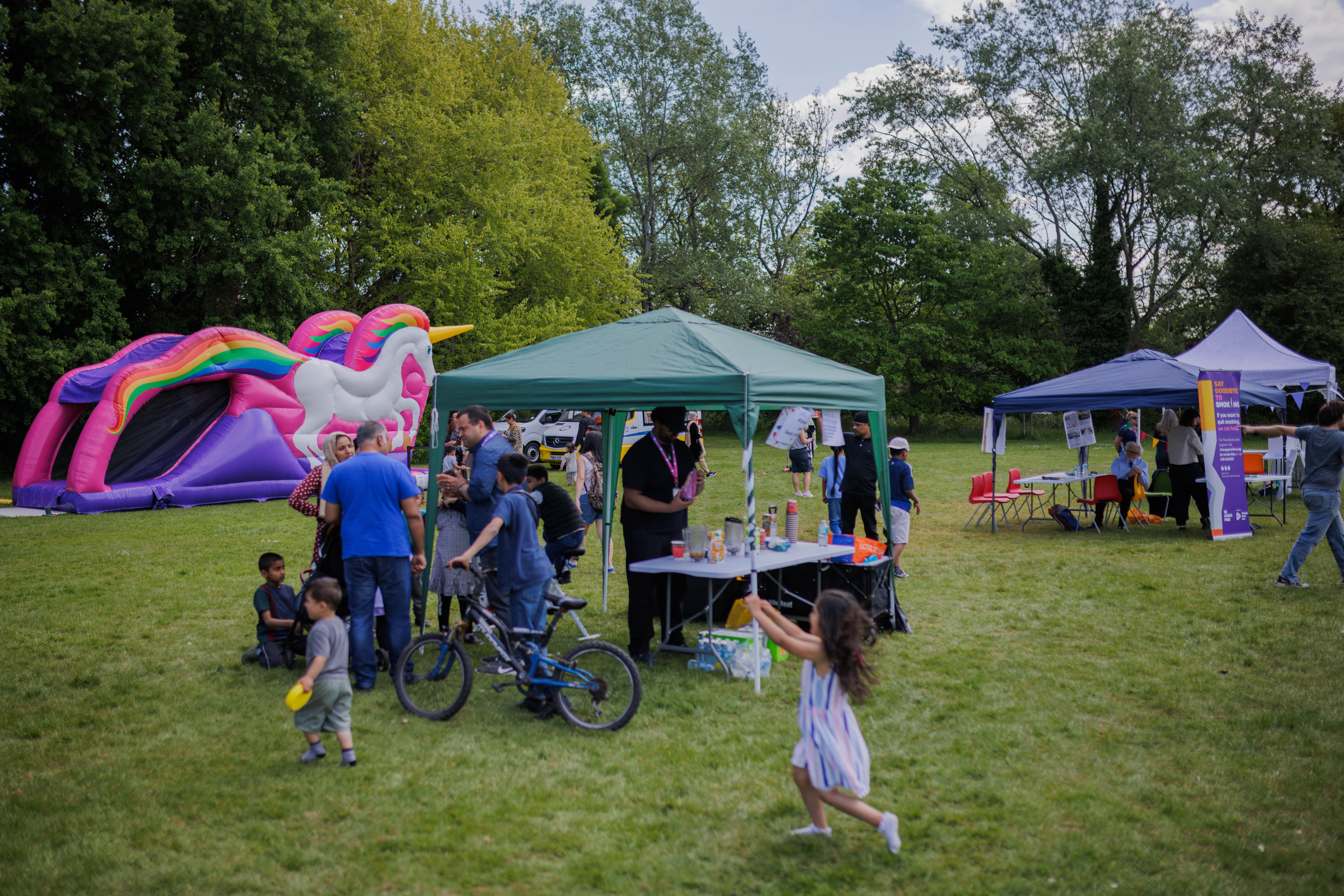children playing near activity stalls at a summer event