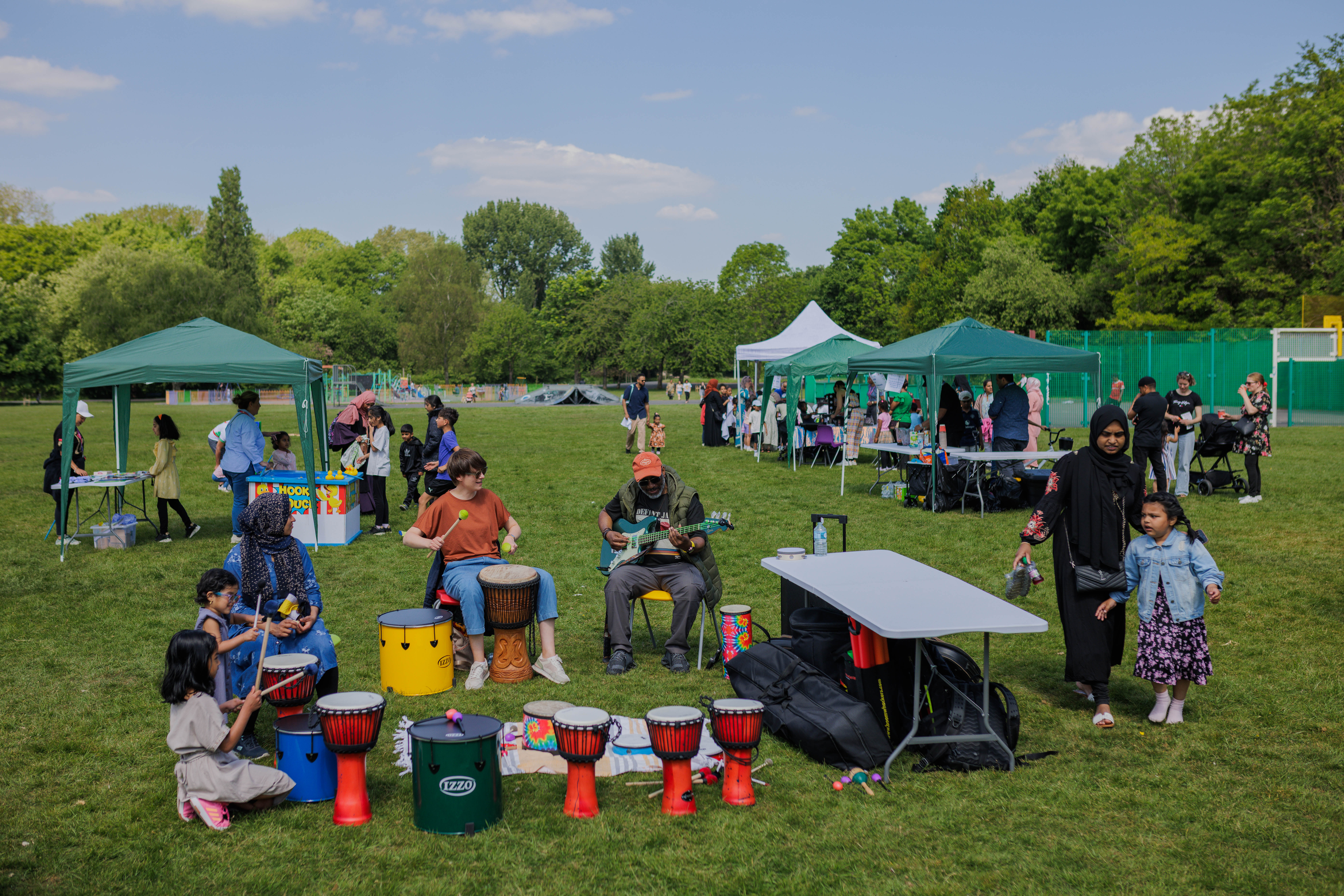 customers playing music together in a circle at a summer event