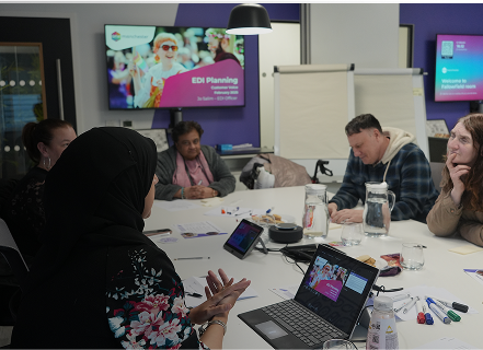 A group of people sat around a table discussing Equality, Diversity and Inclusion