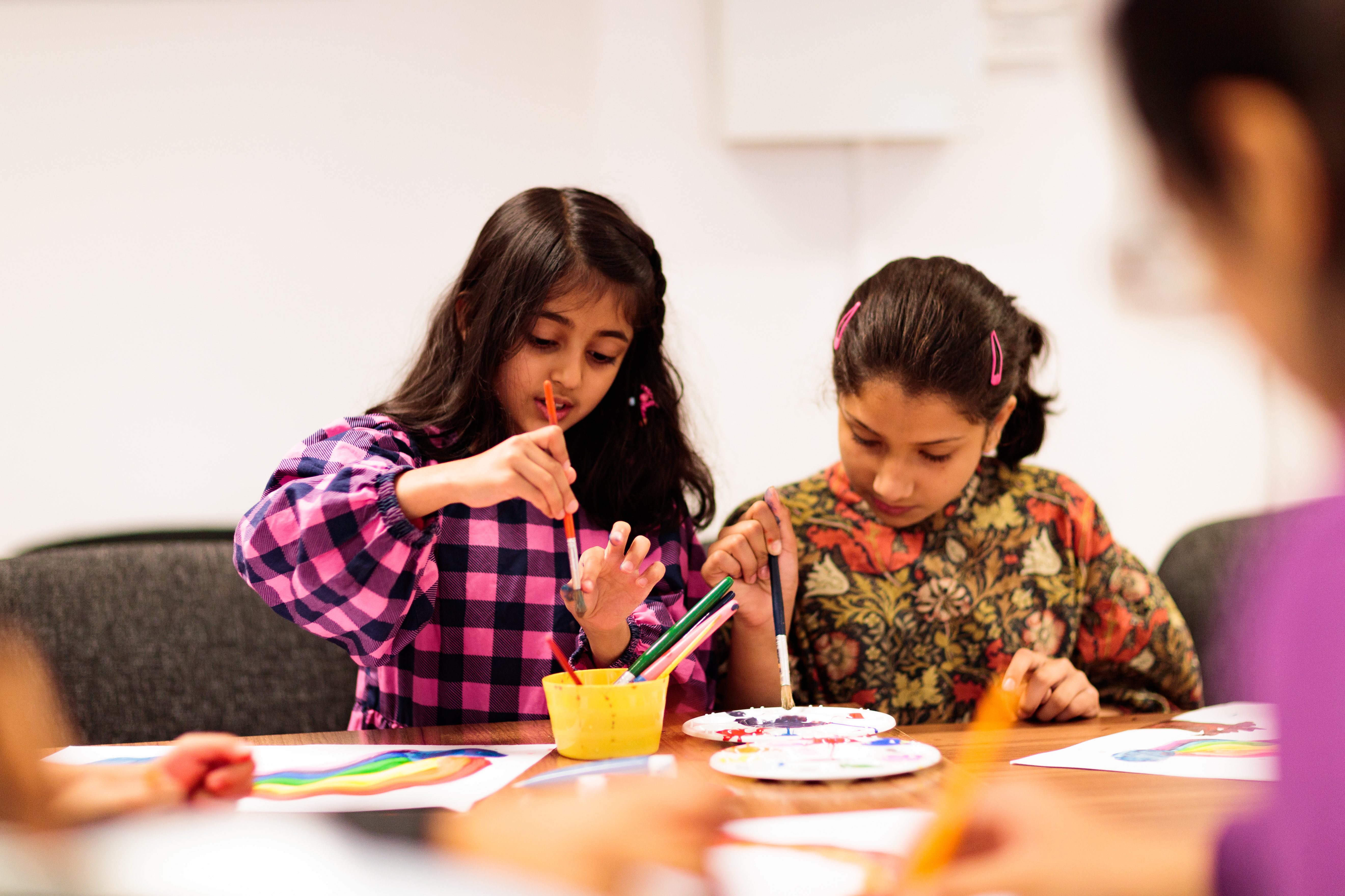 An image of two  young children painting