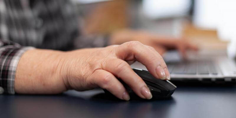 Photo of woman's hand using a computer mouse