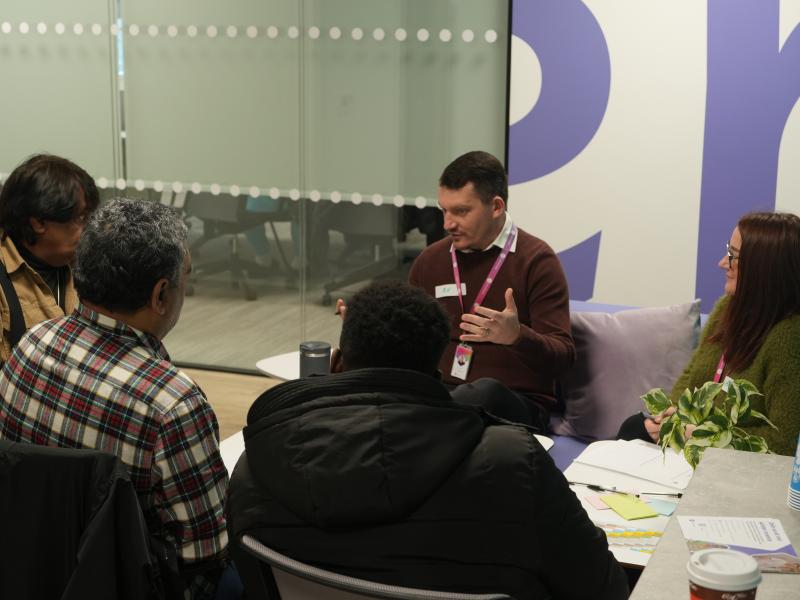 customer speaking to two One Manchester employees