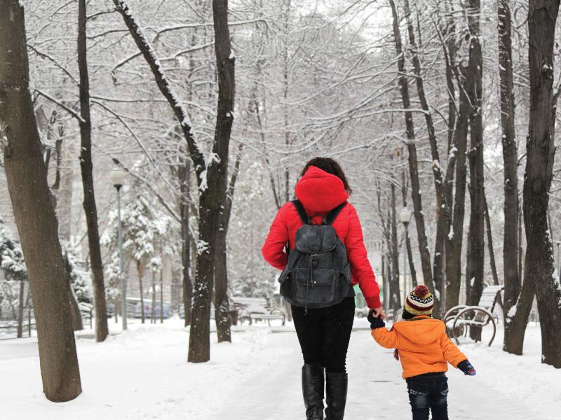 woman and child walking in the snow