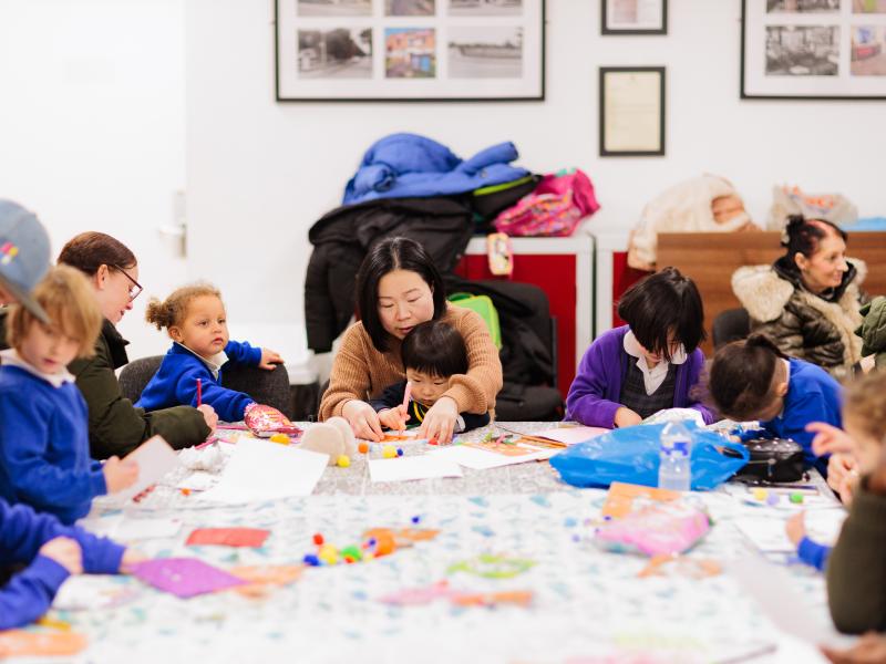 Children and adult working on fun arts