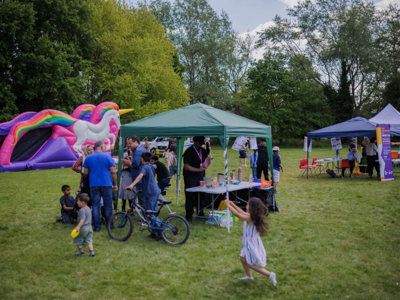 children playing near activity stalls at a summer event