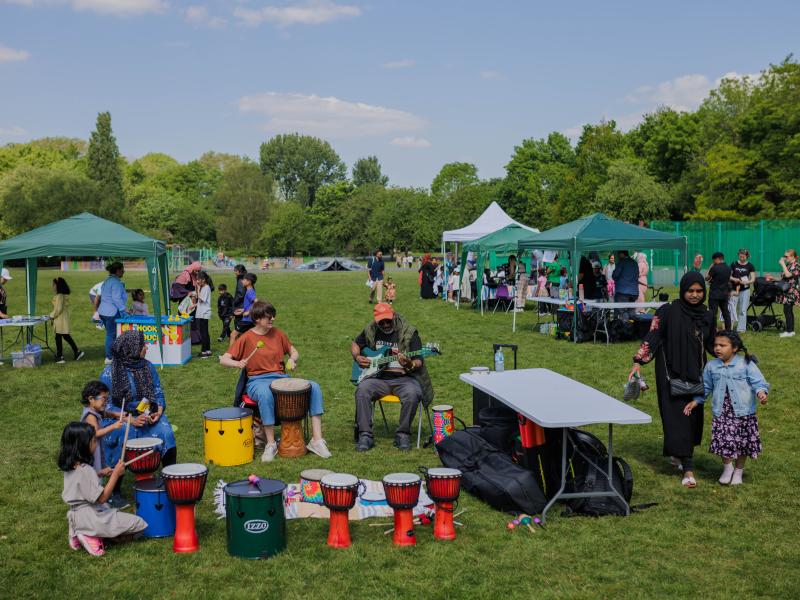 customers playing music together in a circle at a summer event