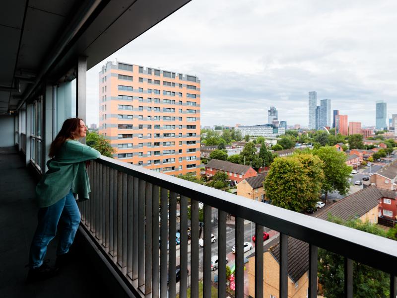 Woman looking over the edge of a building