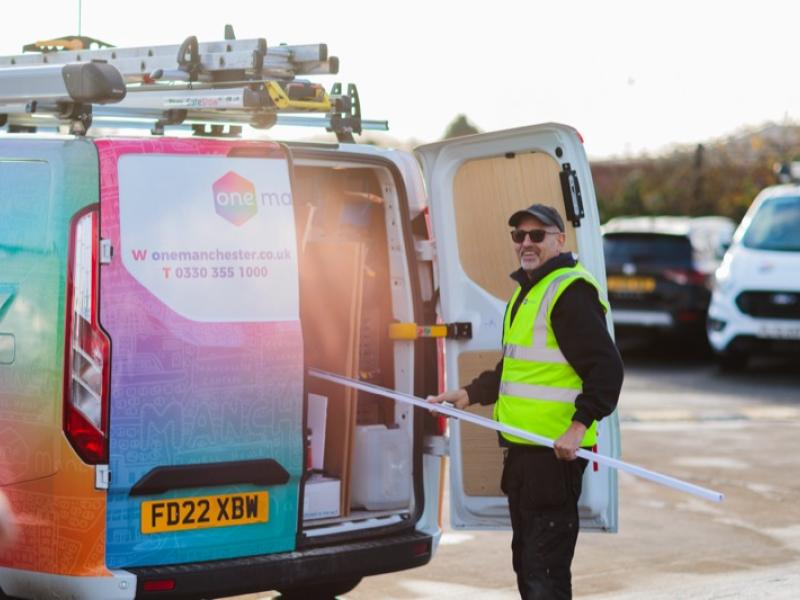 A One Manchester Operative loading materials into their van. 