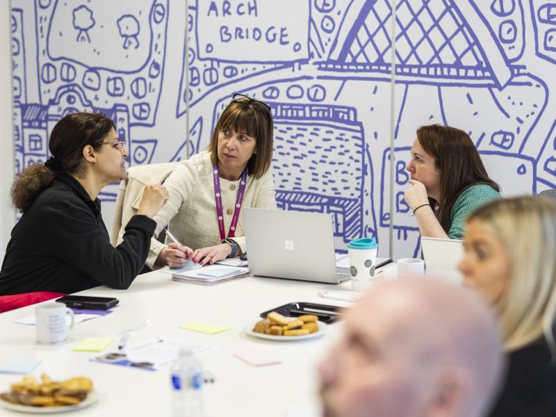 Three people in discussion