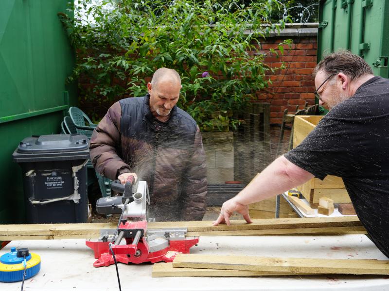 Community Fund project members working with tools and wood