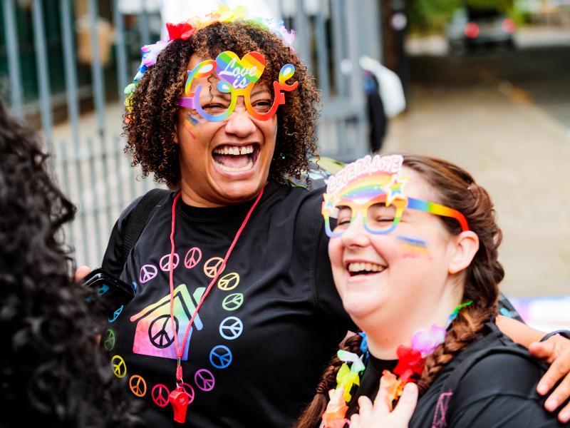 Two people smiling at Pride