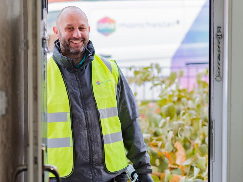 A tradesperson stood in a doorway 