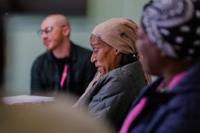 People sat around a table in discussion
