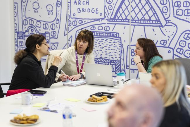 Customer having a conversation with a colleague at a panel session