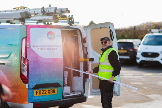 A One Manchester Operative loading materials into their van. 