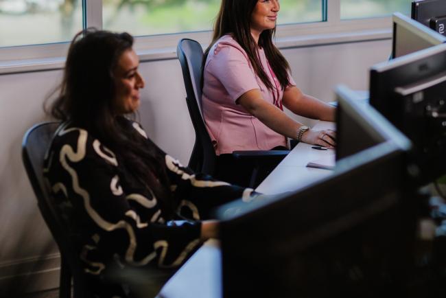 Two colleagues on calls