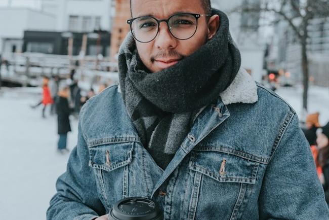 Person holding a coffee in winter