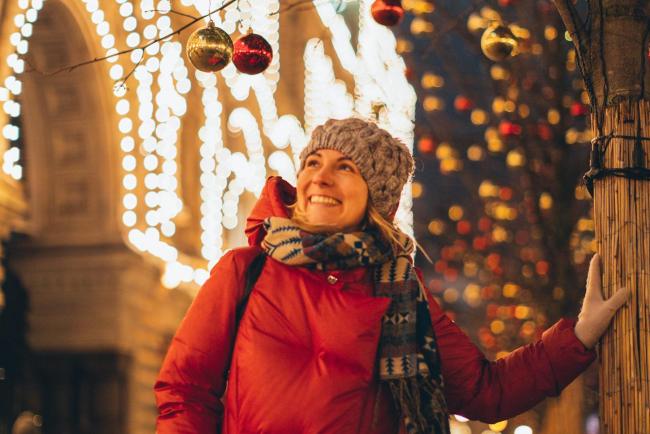 Person standing looking at winter lights